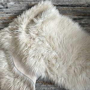 Faux white fir area rug roughly 4 ft long